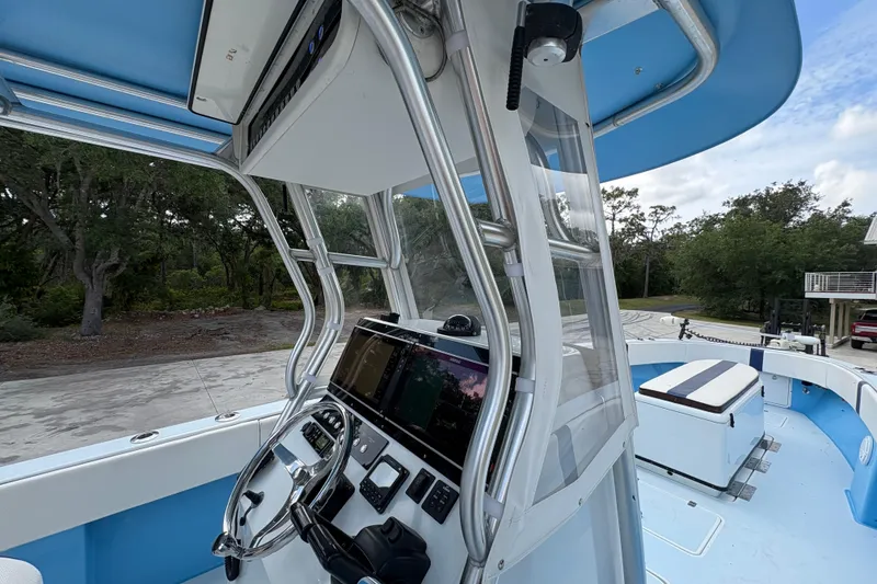 Slide: The Image of 2018 Catamaran Coaches 38 Lightning boat interior with steering console and seating area. - 35