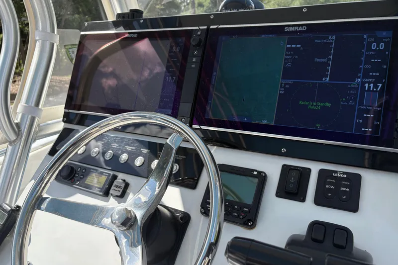 Slide: The Image of Control panel of a 2018 Catamaran Coaches 38 Lightning with navigation screens and steering wheel. - 37