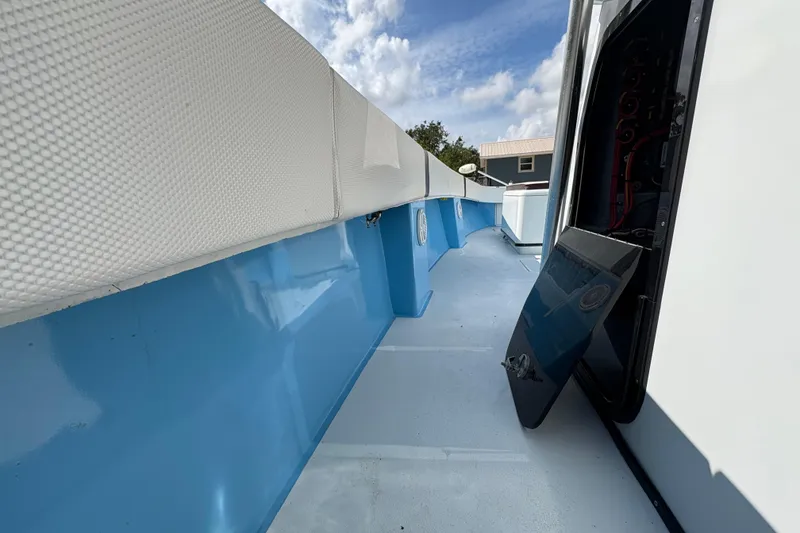 Slide: The Image of 2018 Catamaran Coaches 38 Lightning deck with open hatch, blue and white design. - 46