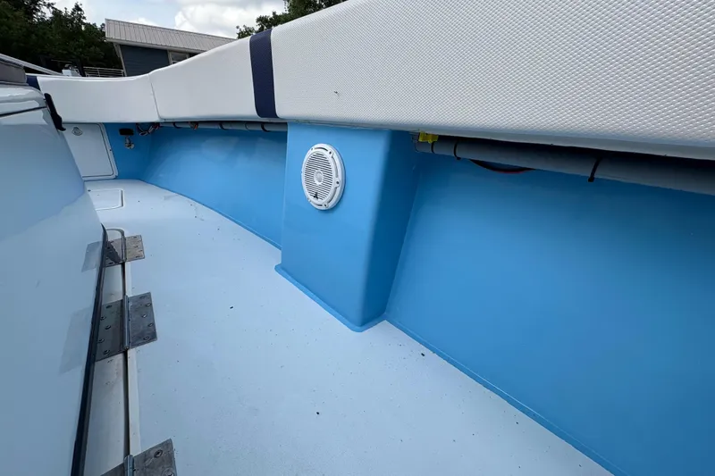Slide: The Image of Interior view of a 2018 Catamaran Coaches 38 Lightning boat, featuring blue and white seating. - 47