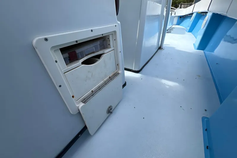 Slide: The Image of 2018 Catamaran Coaches 38 Lightning boat interior with storage compartment open. - 50