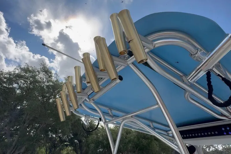 Slide: The Image of 2018 Catamaran Coaches 38 Lightning boat with rod holders under a blue sky. - 53