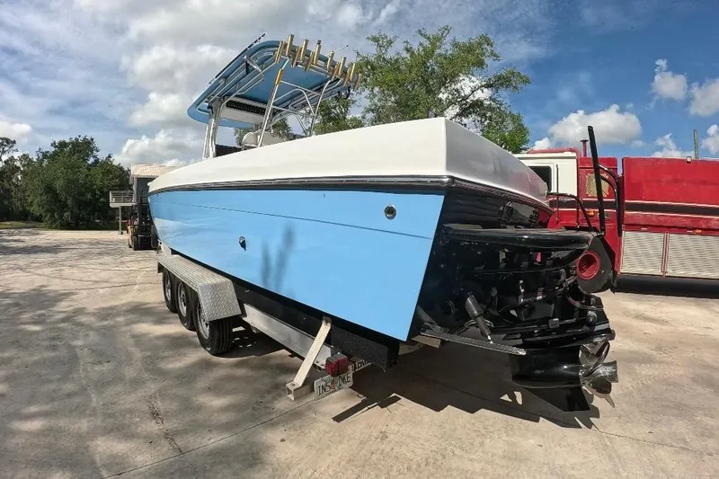 Slide: The Image of 2018 Catamaran Coaches 38 Lightning boat on trailer, blue and white design, sunny day. - 9