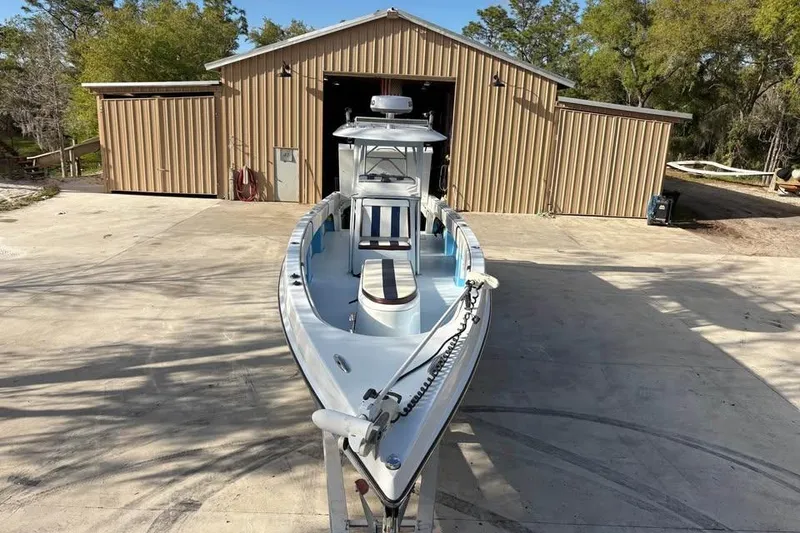 Slide: The Image of 2018 Catamaran Coaches Lightning Powerboats in front of a large shed. - 2