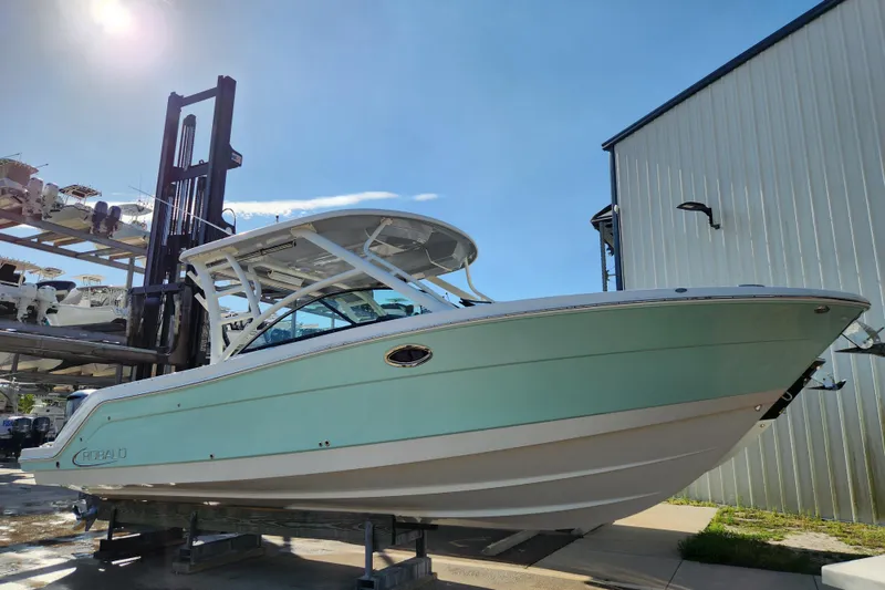 The Image of 2019 Robalo R317 Dual Console boat on display under clear blue sky. - 0