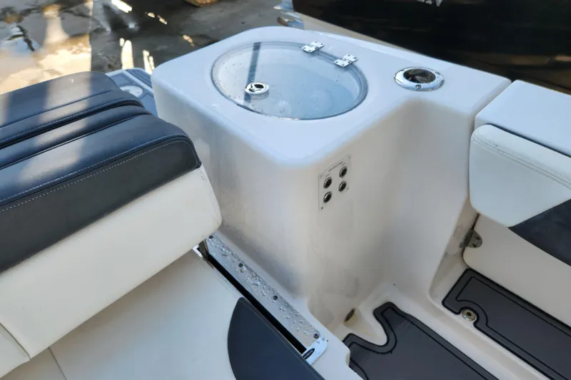Slide: The Image of 2019 Robalo R317 Dual Console boat interior with seating and storage compartment. - 10