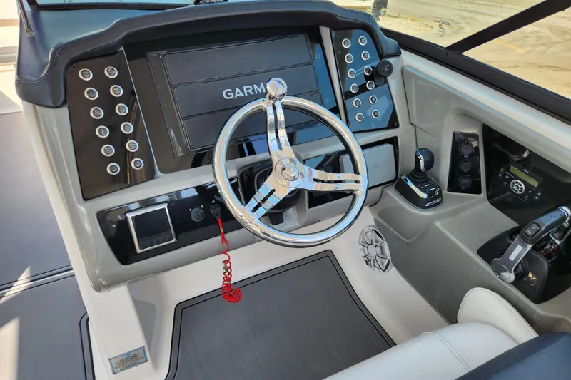 Slide: The Image of 2019 Robalo R317 Dual Console helm with Garmin display and modern controls. - 13