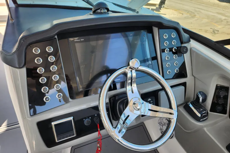 Slide: The Image of 2019 Robalo R317 Dual Console helm with modern controls and steering wheel. - 14