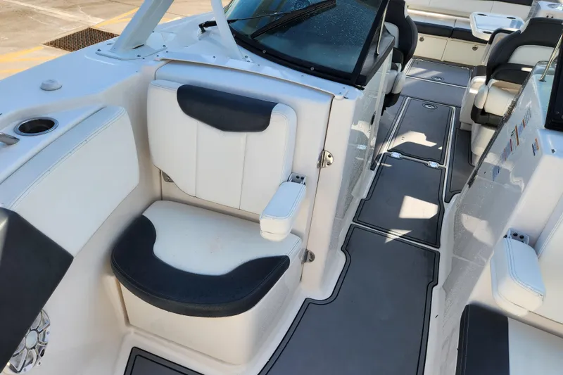 Slide: The Image of 2019 Robalo R317 Dual Console boat interior with seating and cup holders. - 18