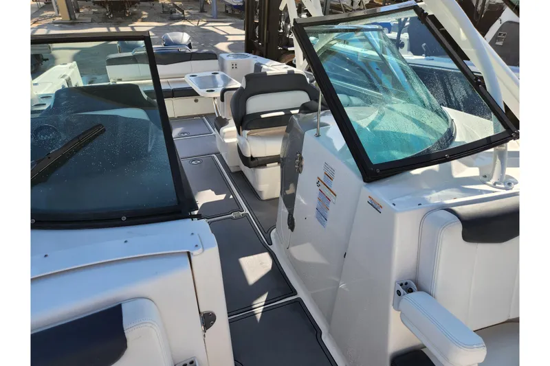 Slide: The Image of 2019 Robalo R317 Dual Console boat interior with seating and windshield. - 19