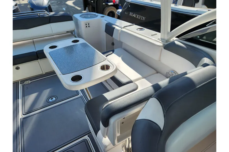 Slide: The Image of 2019 Robalo R317 Dual Console boat interior with seating and table setup. - 22