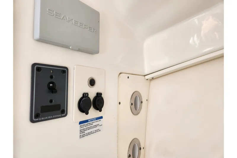 Slide: The Image of 2019 Robalo R317 Dual Console boat controls and Seakeeper system panel. - 24