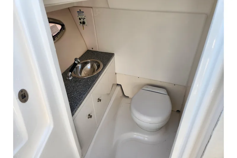 Slide: The Image of 2019 Robalo R317 Dual Console boat bathroom with sink and toilet. - 25