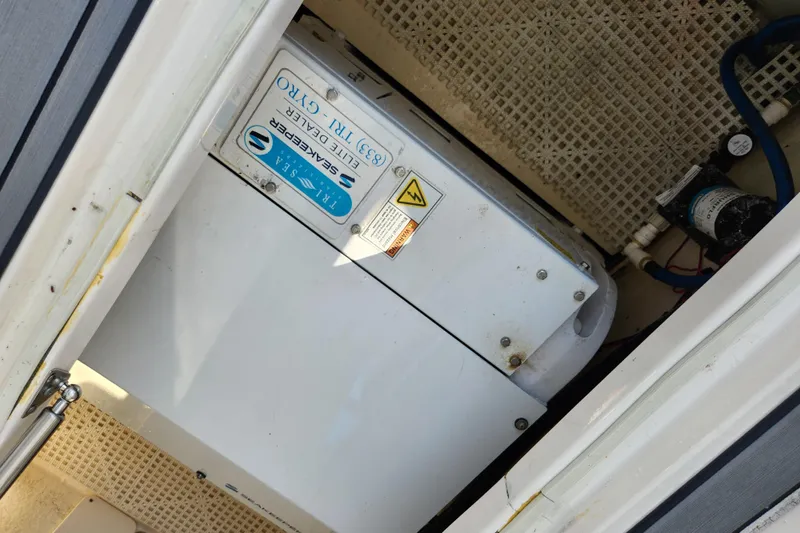 Slide: The Image of 2019 Robalo R317 Dual Console boat equipment compartment with electrical components. - 27