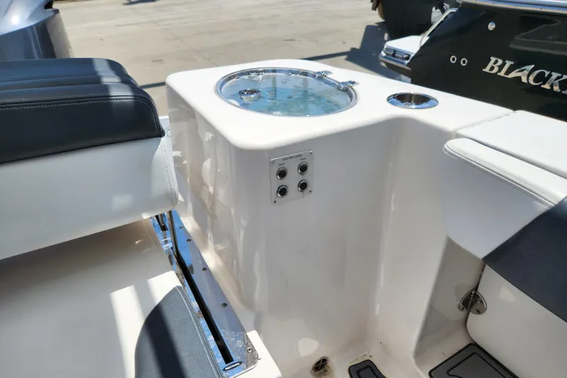 Slide: The Image of 2019 Robalo R317 Dual Console boat interior with seating and livewell. - 29