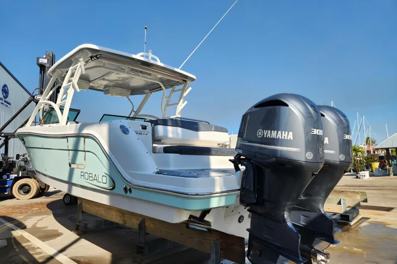 Slide: The Image of 2019 Robalo R317 Dual Console boat with twin Yamaha 300 engines on display. - 3