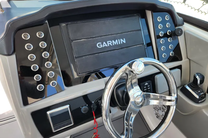Slide: The Image of 2019 Robalo R317 Dual Console dashboard with Garmin display and steering wheel. - 32