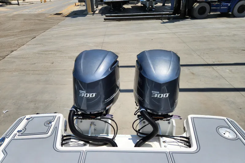 Slide: The Image of 2019 Robalo R317 Dual Console with twin Yamaha 300 engines at a dock. - 33