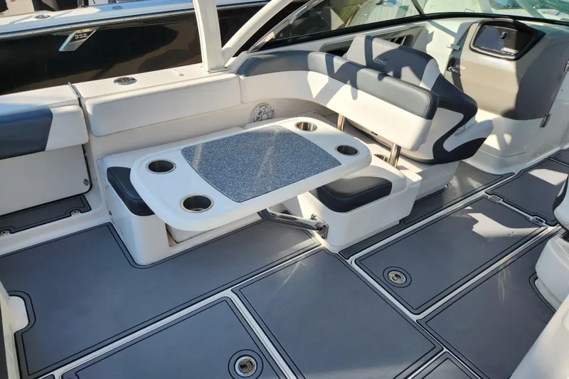 Slide: The Image of 2019 Robalo R317 Dual Console boat interior with seating and table setup. - 7