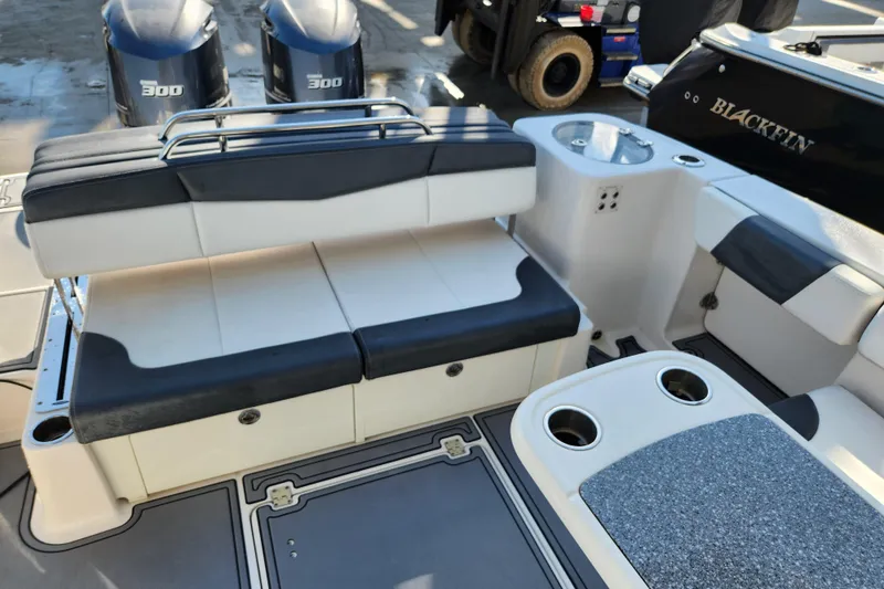 Slide: The Image of 2019 Robalo R317 Dual Console boat interior with seating and twin 300 engines. - 8