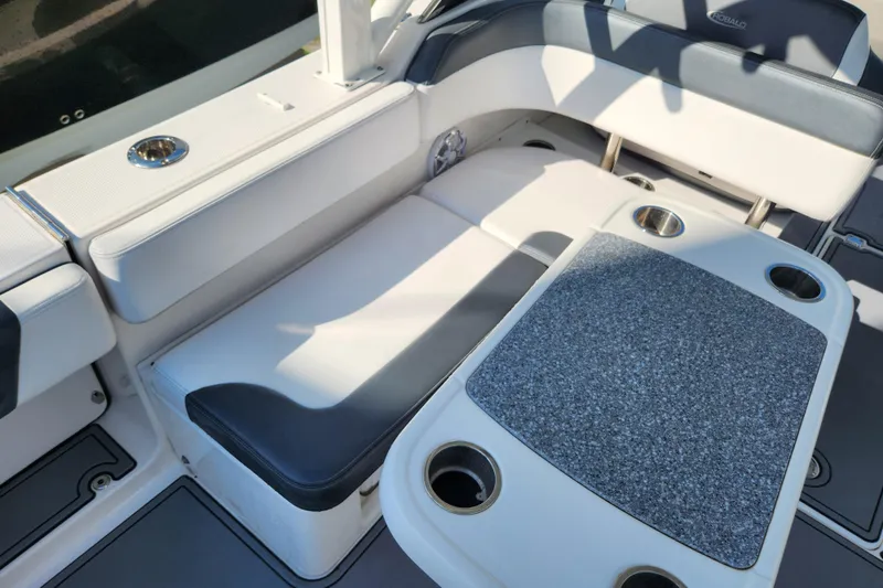 Slide: The Image of 2019 Robalo R317 Dual Console boat interior with cushioned seating and table. - 9