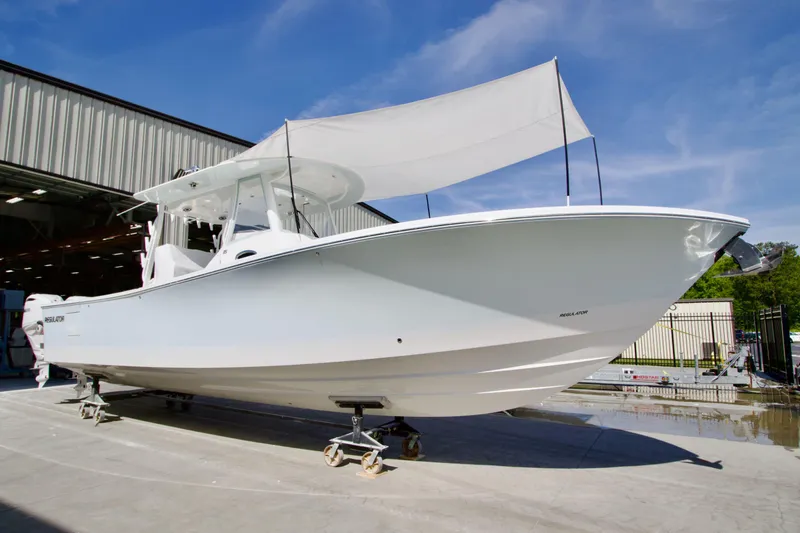 The Image of 2026 Regulator 35 boat with canopy, displayed outdoors under blue sky. - 0