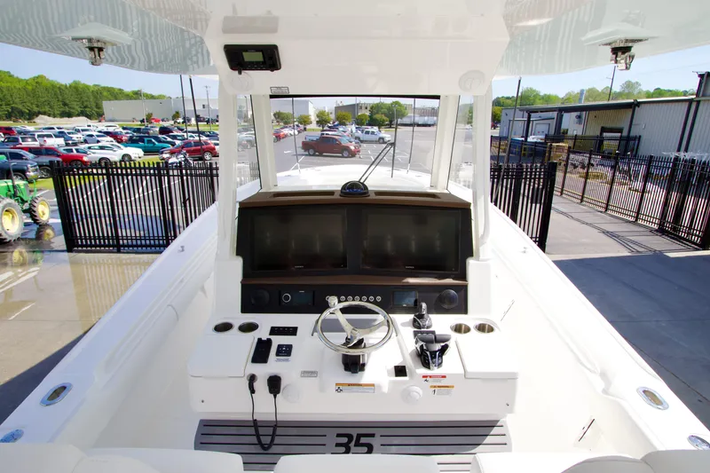 Slide: The Image of 2026 Regulator 35 boat cockpit with modern controls and dual screens. - 12