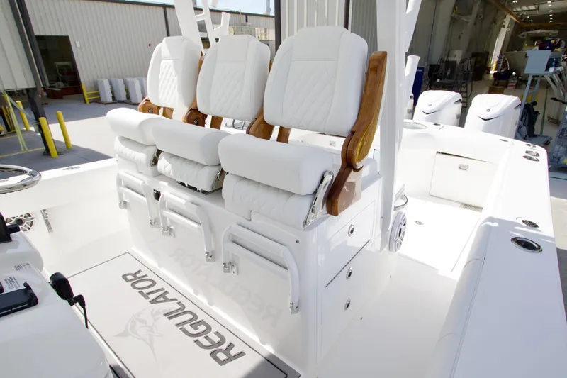 Slide: The Image of 2026 Regulator 35 boat interior with white cushioned seating and wooden accents. - 13
