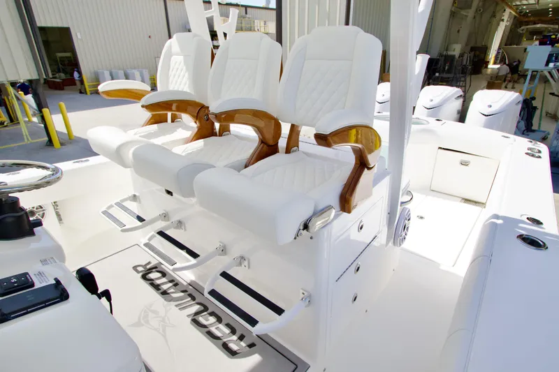 Slide: The Image of Luxury seating on 2026 Regulator 35 boat, featuring white upholstery and wooden accents. - 14
