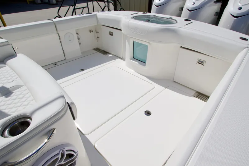 Slide: The Image of 2026 Regulator 35 boat interior with white seating and storage compartments. - 17
