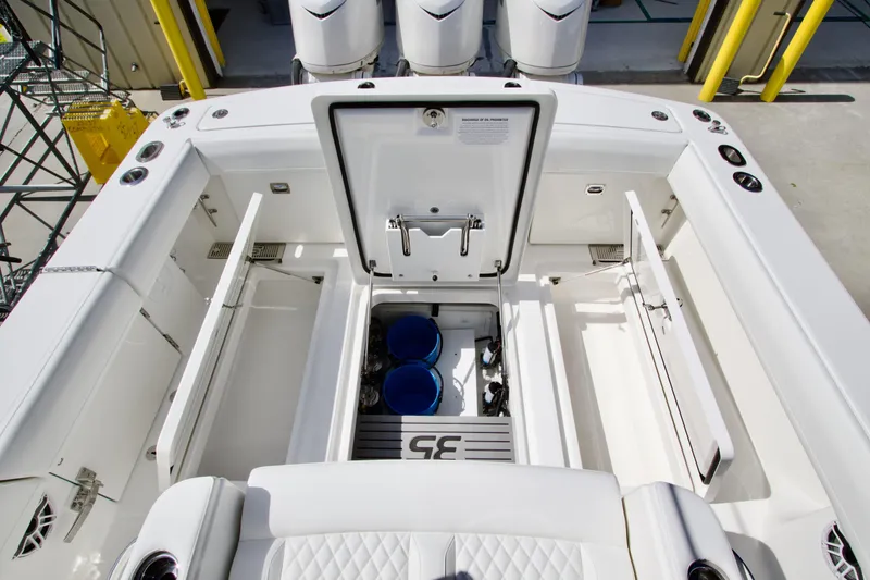Slide: The Image of 2026 Regulator 35 boat interior with open storage compartments and visible engine components. - 18