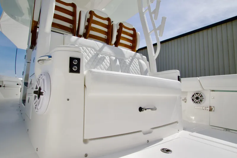 Slide: The Image of 2026 Regulator 35 boat interior with white seating and wooden accents. - 20