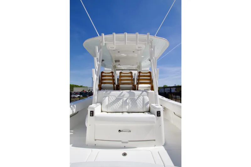 Slide: The Image of 2026 Regulator 35 boat interior with seating, under clear blue sky. - 26