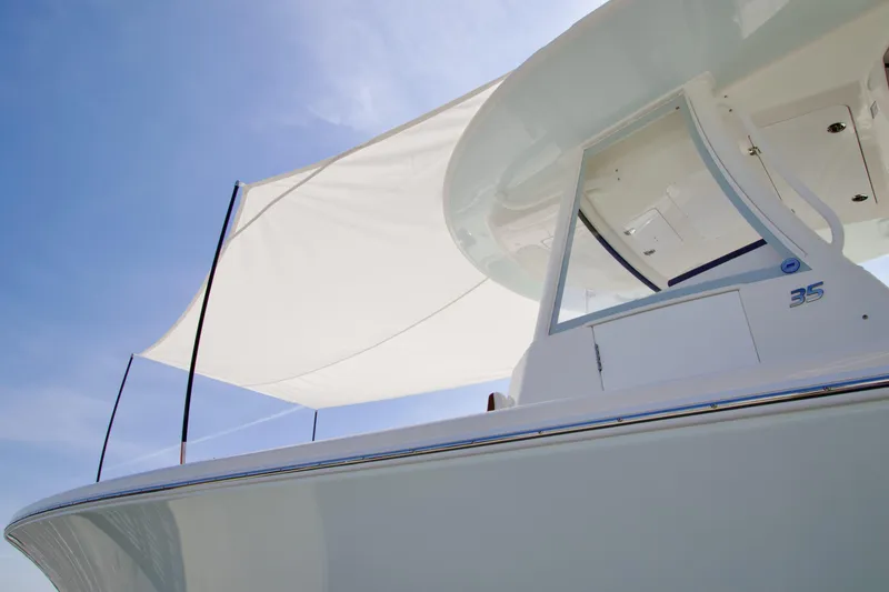 Slide: The Image of 2026 Regulator 35 boat with sleek design and sunshade against clear blue sky. - 28
