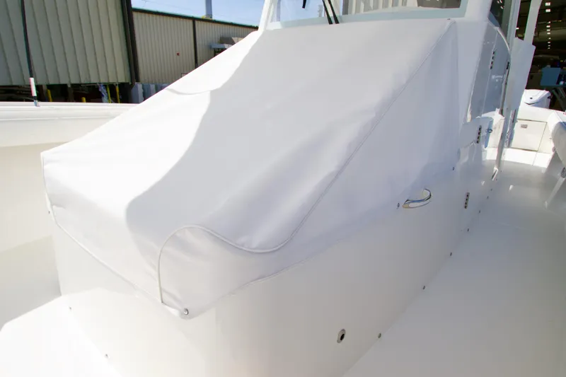 Slide: The Image of 2026 Regulator 35 boat with white protective cover in a marina setting. - 3