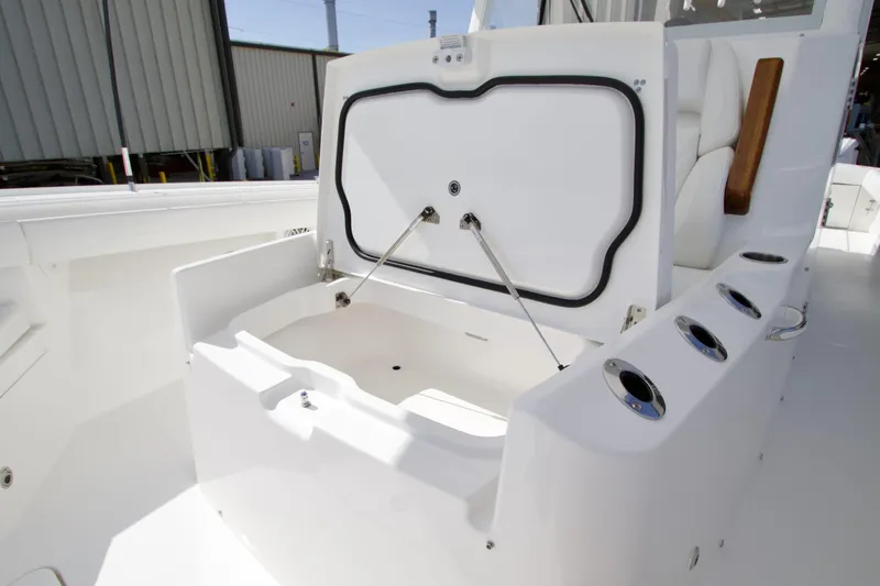 Slide: The Image of 2026 Regulator 35 boat with open storage compartment and rod holders. - 6
