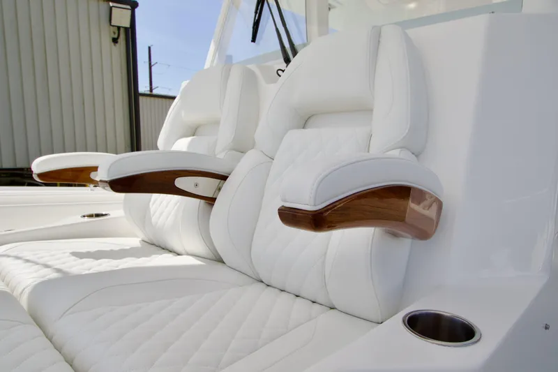 Slide: The Image of Luxurious white seating with wooden armrests on 2026 Regulator 35 boat. - 9