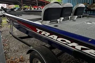 Slide: The Image of 2017 Tracker Pro Team 175 TF boat on trailer, side view with seats visible. - 8