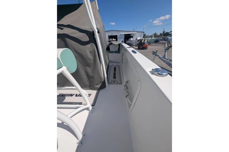 Slide: The Image of 2024 Twin Vee 240 GFX CC boat deck with covered seating and clear sky. - 12