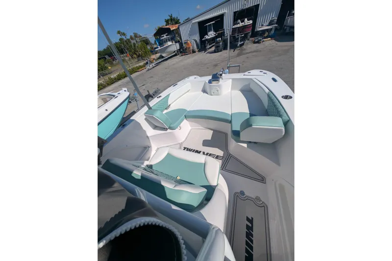 Slide: The Image of 2024 Twin Vee 240 GFX CC boat interior with teal and white seating. - 3