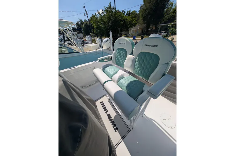 Slide: The Image of 2024 Twin Vee 240 GFX CC boat seats with teal and white upholstery. - 6