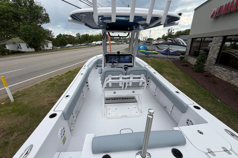 Slide: The Image of 2026 Sportsman Open 232 Center Console boat displayed outdoors near dealership. - 13