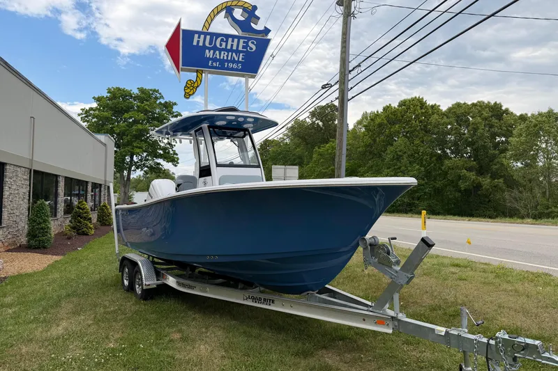 Slide: The Image of 2026 Sportsman Open 232 Center Console boat on trailer at Hughes Marine dealership. - 4