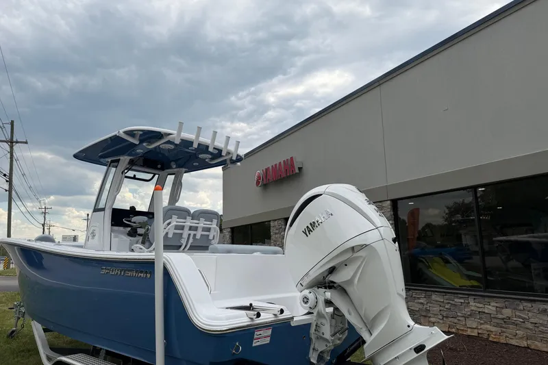 Slide: The Image of 2026 Sportsman Open 232 Center Console boat with Yamaha engine outside dealership. - 5