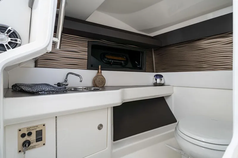Slide: The Image of Manufacturer Provided Image: 2022 Sea Ray SLX 310 OB boat interior with modern bathroom amenities. - 11