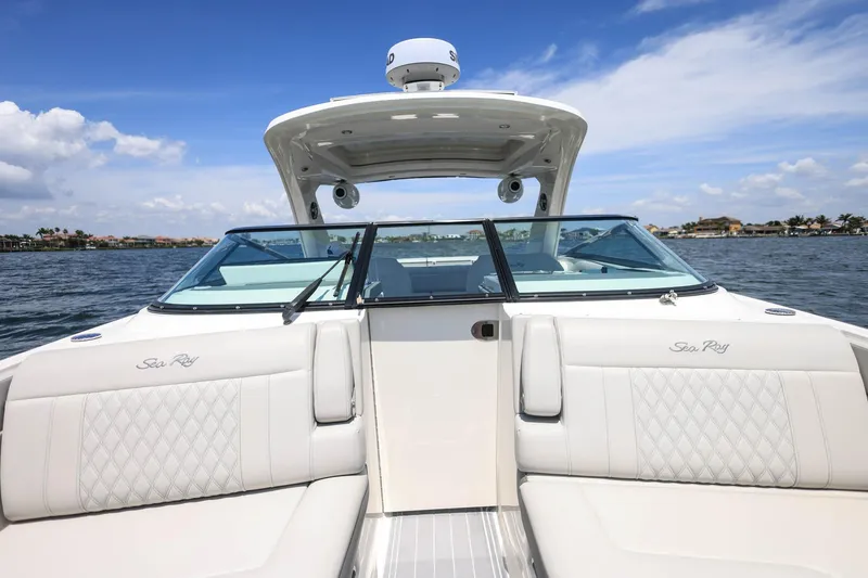 Slide: The Image of 2022 Sea Ray SLX 310 Outboard boat on water, featuring luxurious seating and sleek design. - 14