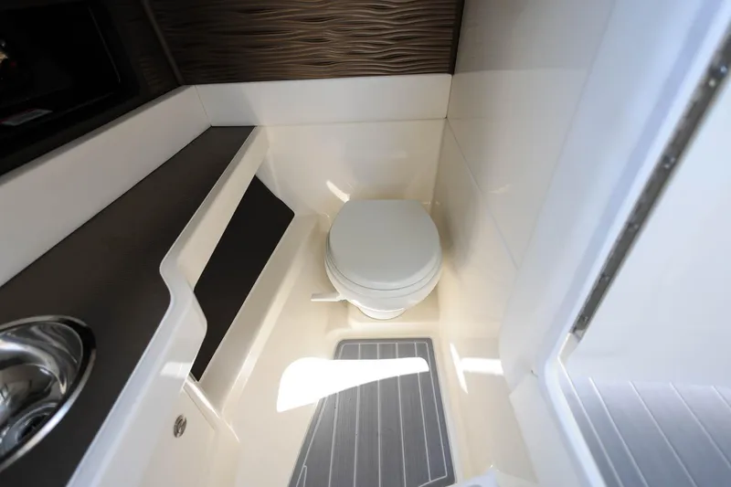 Slide: The Image of 2022 Sea Ray SLX 310 Outboard boat bathroom with toilet and sink. - 17