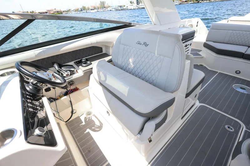 Slide: The Image of 2022 Sea Ray SLX 310 Outboard boat interior with luxurious seating and modern controls. - 25