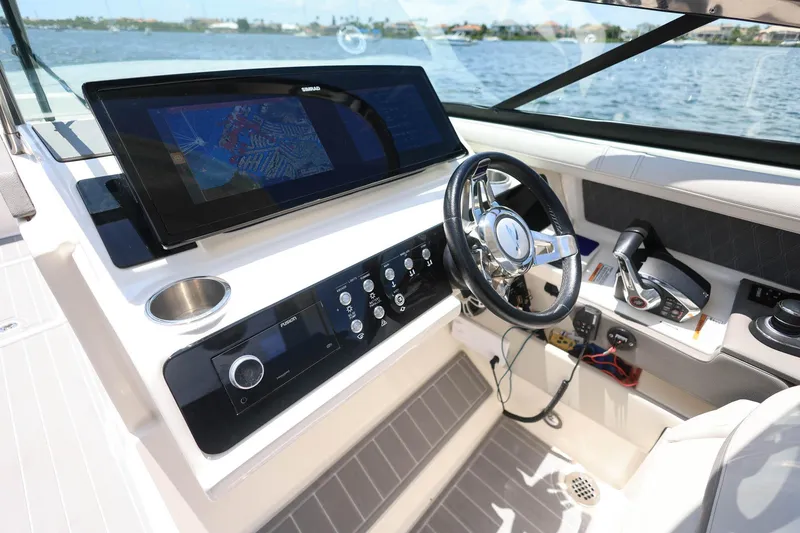 Slide: The Image of 2022 Sea Ray SLX 310 Outboard helm with advanced navigation system and controls. - 26