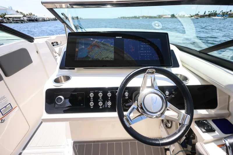 Slide: The Image of 2022 Sea Ray SLX 310 Outboard helm with modern navigation display and controls. - 28